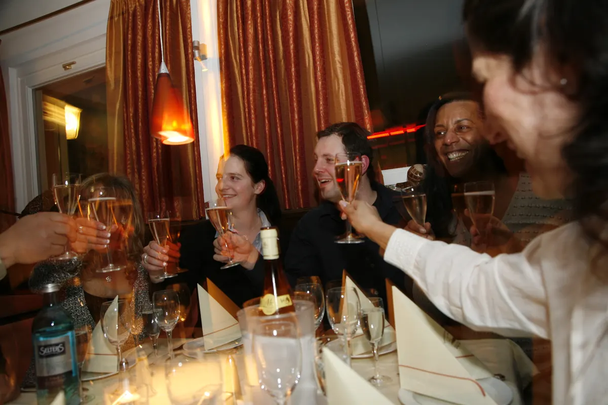 Guests raising their glasses at a celebration in Restaurante Porto