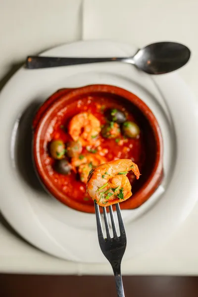 King prawns in tomato sauce in a clay pot